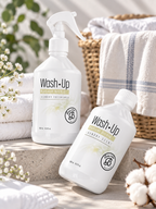 Parfum de linge Wash·Up Radiant Orchid 500 ml présenté avec vaporisateur et flacon dans une ambiance élégante et lumineuse.