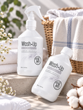 Parfum de linge Wash·Up White Glowing 500 ml présenté avec vaporisateur et flacon dans une ambiance lumineuse avec linge blanc.